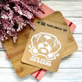 Vinyl decal with a dog illustration and text on a wooden surface with pink flowers.
