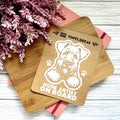 Vinyl decal with a dog illustration and text on a wooden surface with pink flowers.