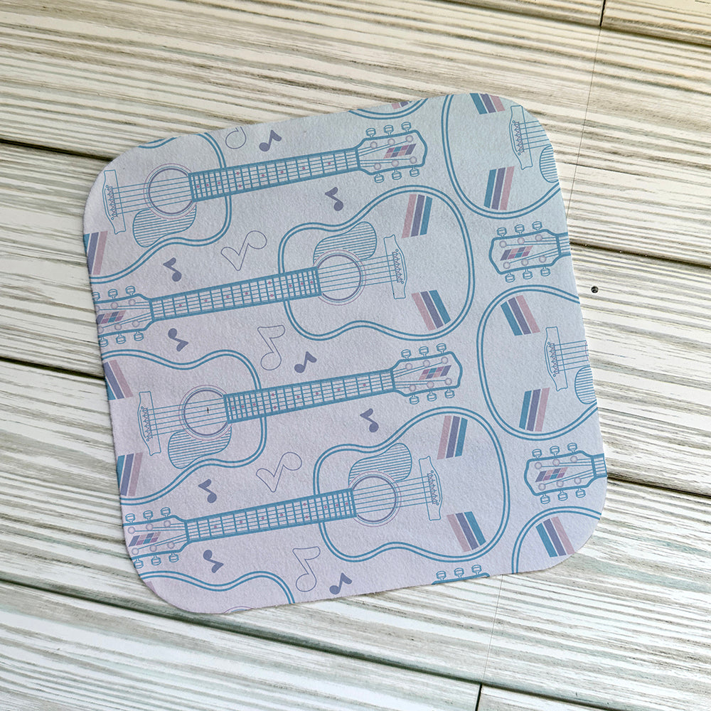 Acoustic guitar pattern on a screen cloth on. light wood ackground