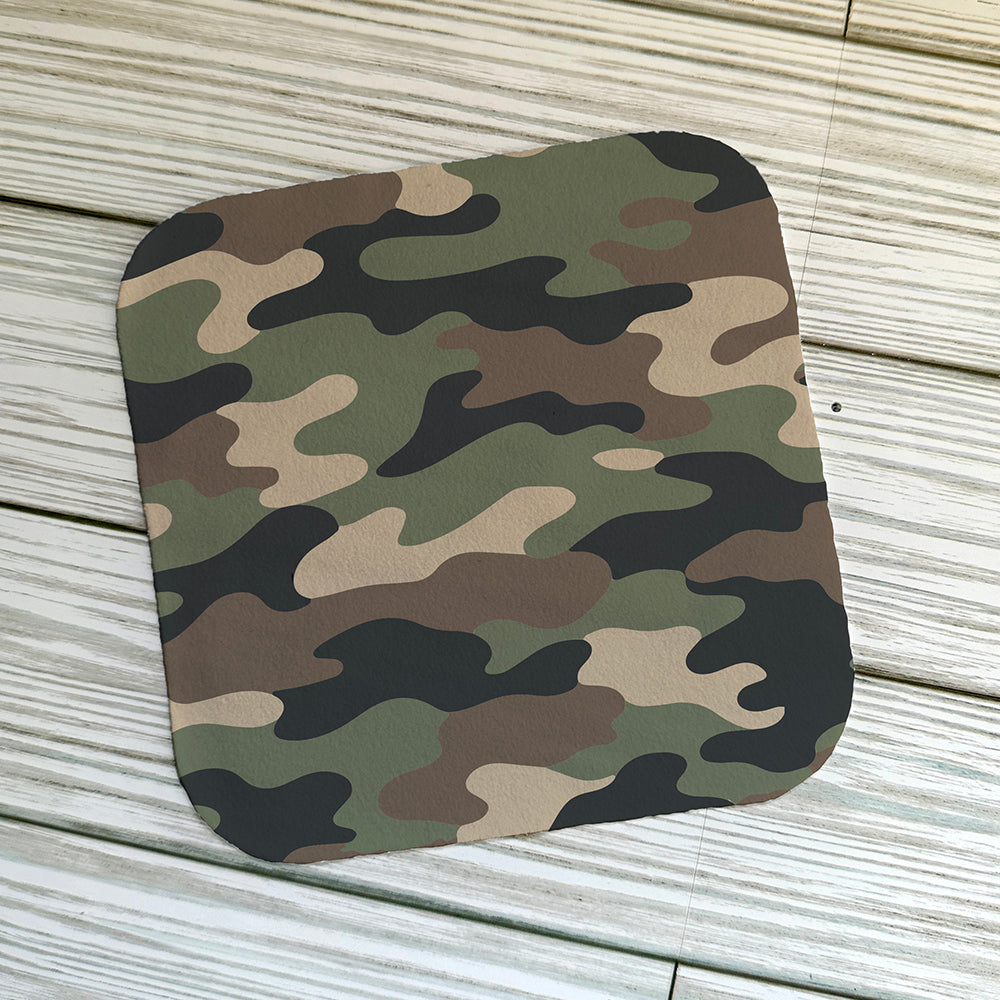 Camouflage pattern on a screen cloth on a light wood background