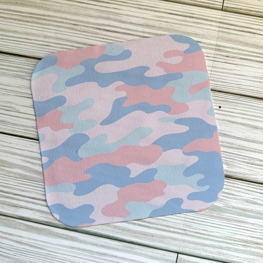 Pink Camouflage pattern on a screen cloth on. light wooden background