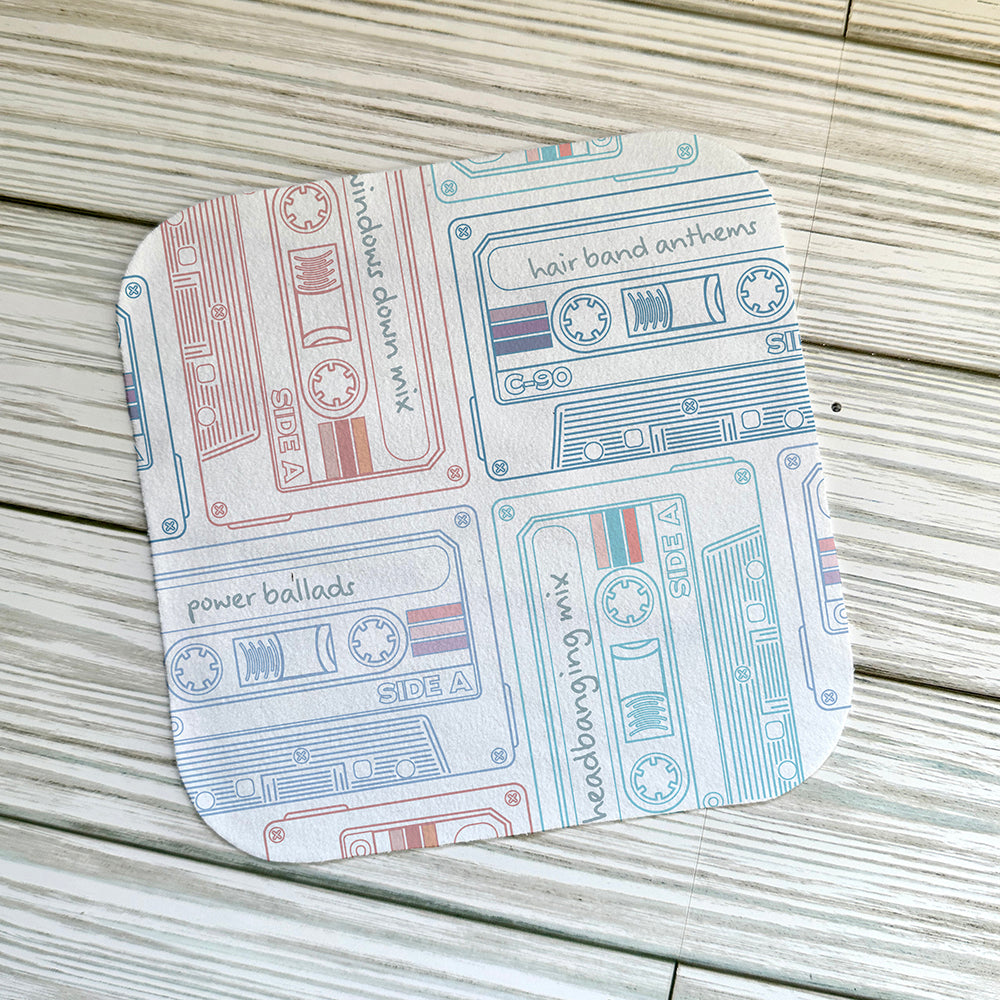 Retro cassette pattern on a screen cloth on a light wood background