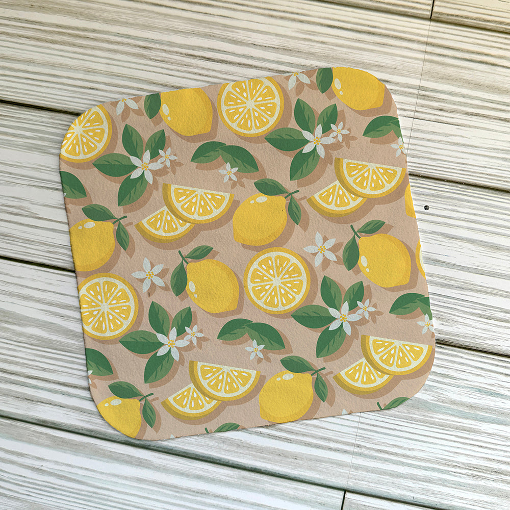 Lemon cleaning cloth on a light wood background
