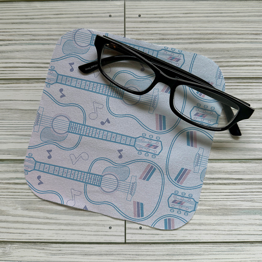 Acoustic guitar pattern on a screen cloth with reading glasses