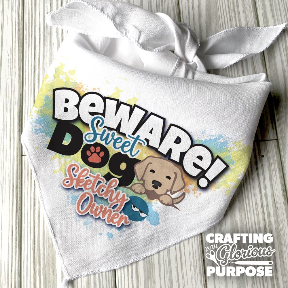 White bandana with colorful text and a puppy graphic on a wooden surface.