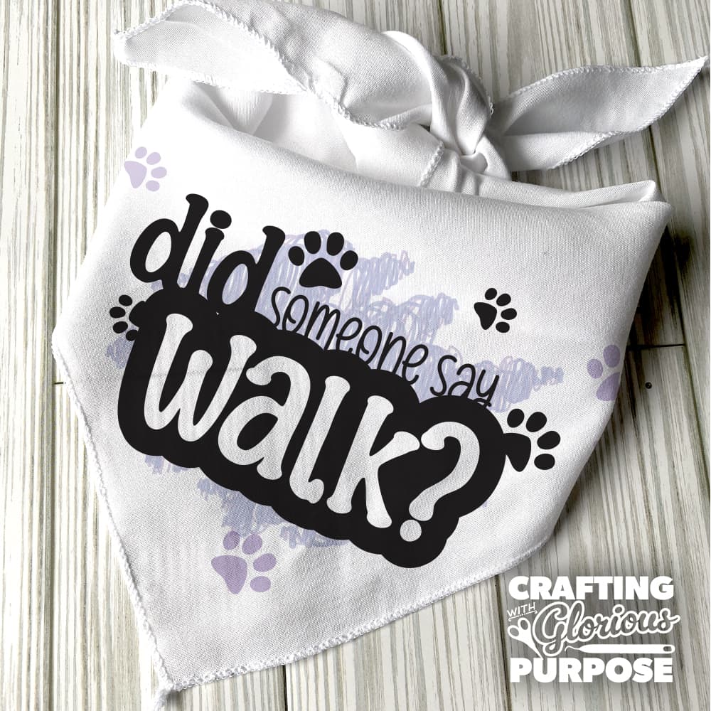 White bandana with text 'did someone say walk?' on a wooden surface