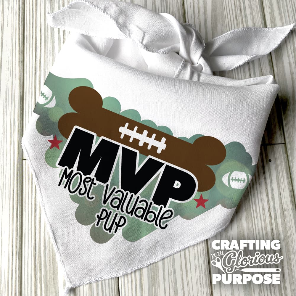 White bandana with 'MVP Most Valuable Pup' text and football design on a wooden surface.