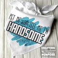 White bandana with 'Pet me and tell me I'm handsome' text on a wooden surface, featuring a white ribbon.