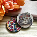 Colorful cat-themed coasters with floral background