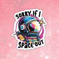Colorful sticker with an astronaut helmet and text 'Sorry if I Space Out' on a pink background