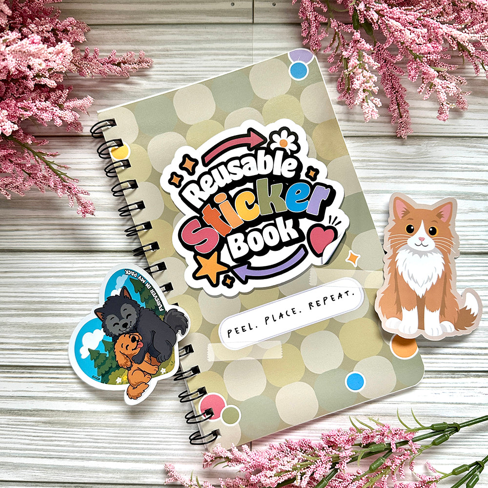 Reusable sticker book surrounded by stickers on wooden surface.