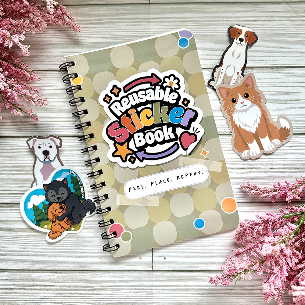 Reusable sticker book surrounded by stickers on wooden surface.