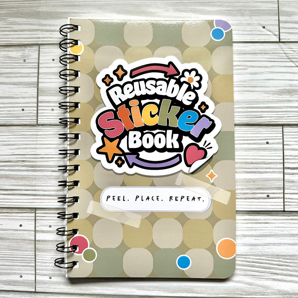 Reusable sticker book on wooden surface.