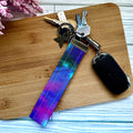 Keychain with colorful strap on a wooden surface