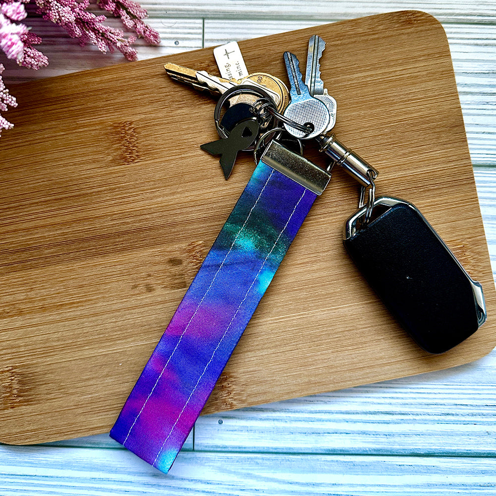 Keychain with colorful strap on a wooden surface