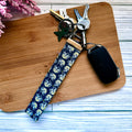 Keychain with floral pattern on a wooden board
