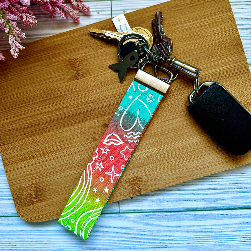 Keychain with colorful strap on a wooden surface