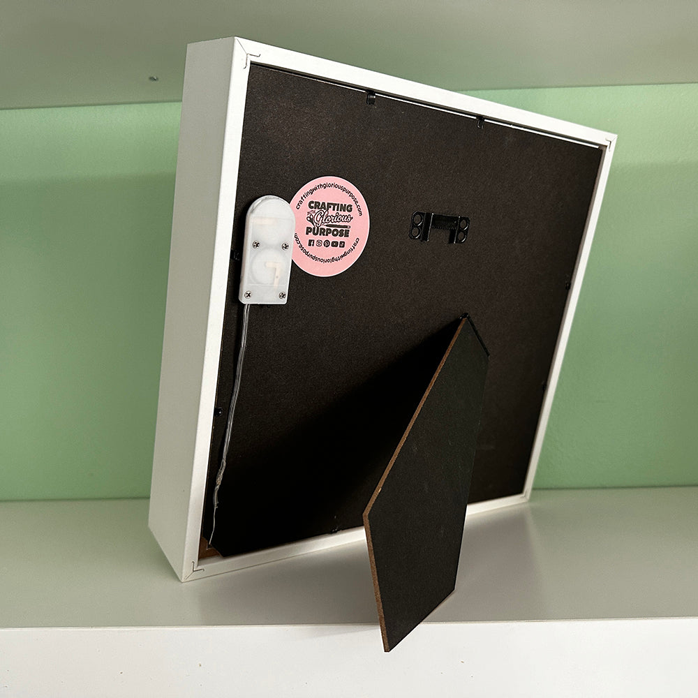 Product packaging with a black back and visible branding on a light green background