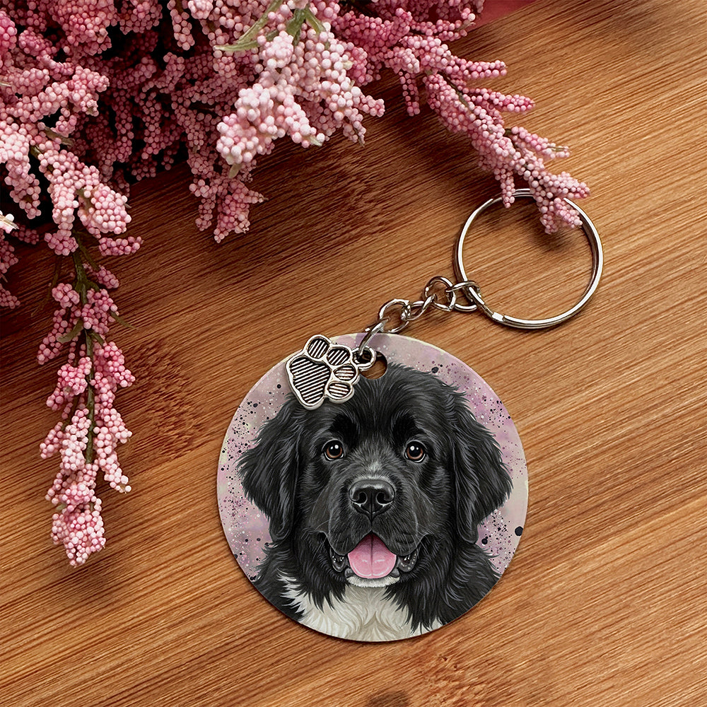 Keychain with a dog's face on a wooden surface with pink flowers