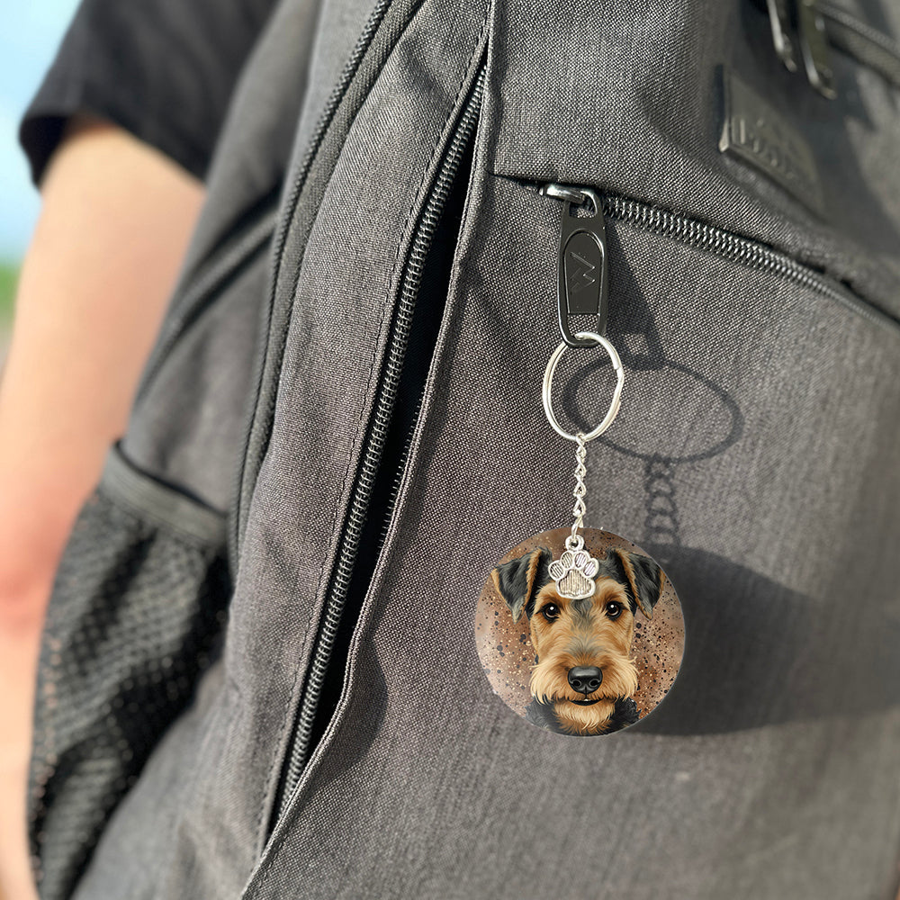 Keychain with a dog's face attached to a gray bag
