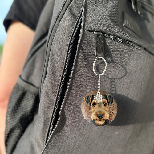 Keychain with a dog's face attached to a gray bag