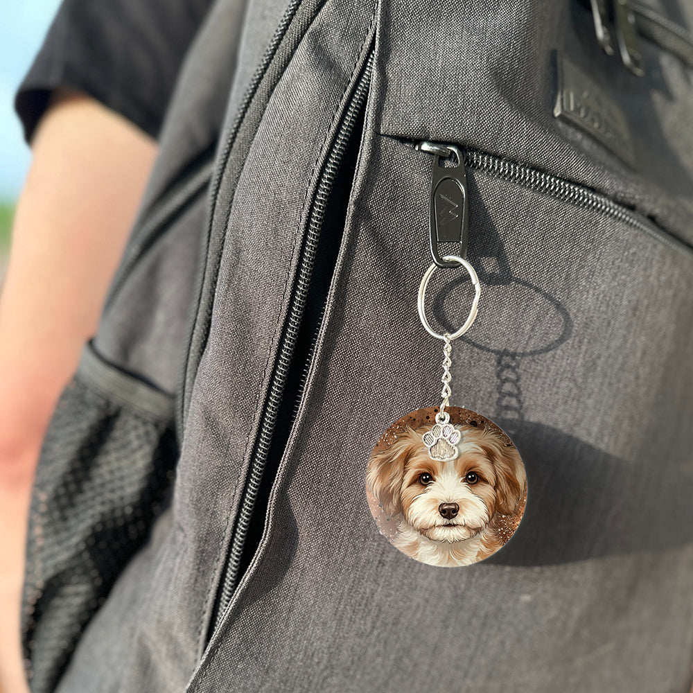 Keychain with a dog's face attached to a gray bag