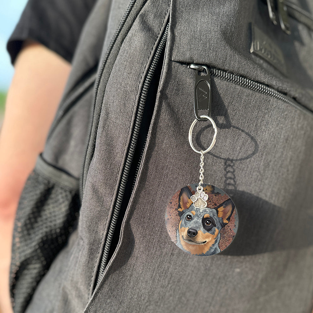 Keychain with a dog's face attached to a gray bag