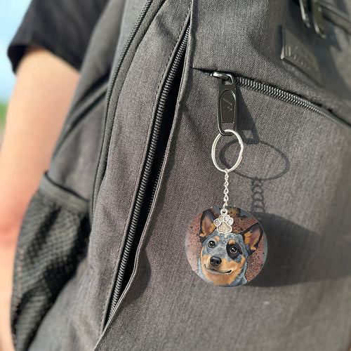 Keychain with a dog's face attached to a gray bag