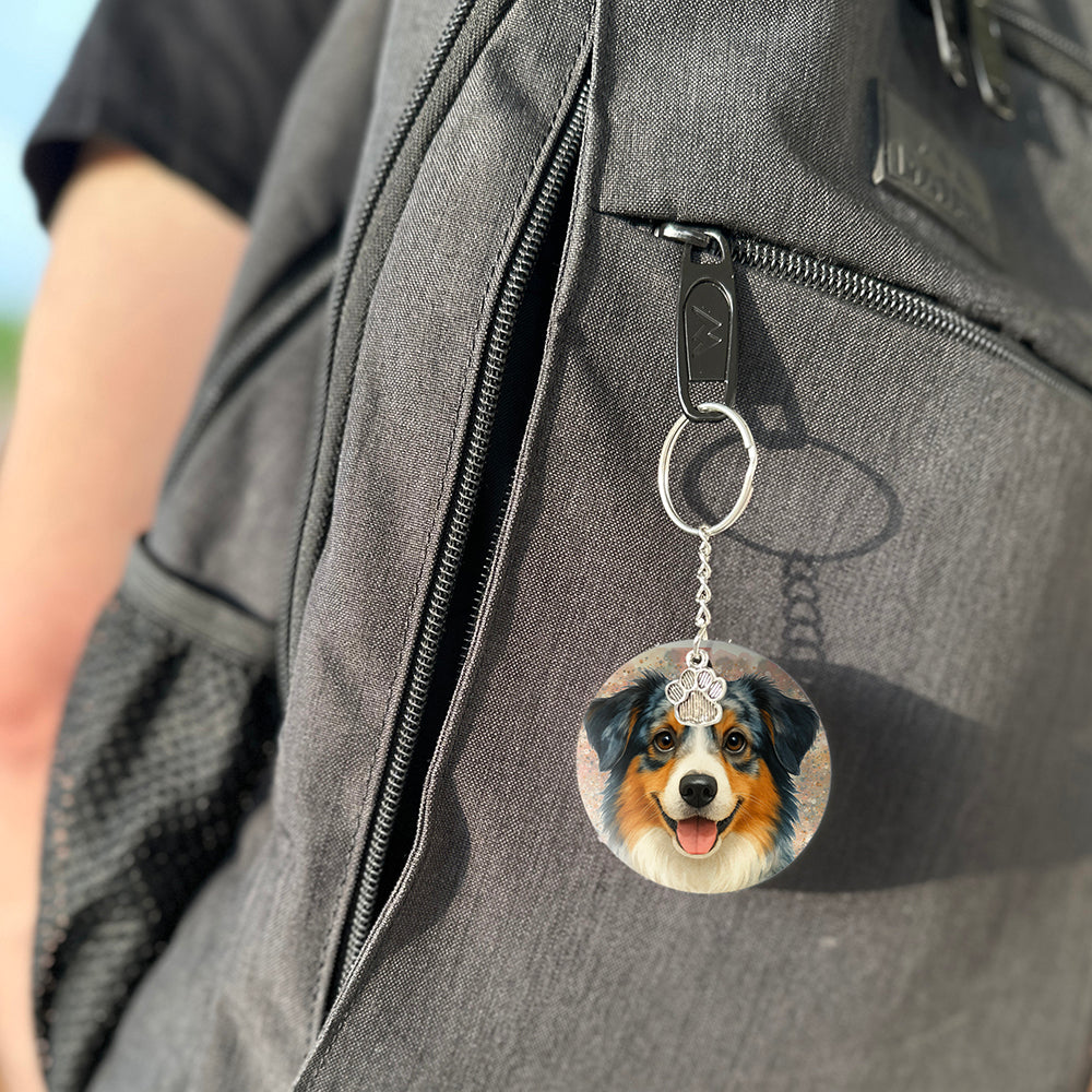 Keychain with a dog's face attached to a gray bag