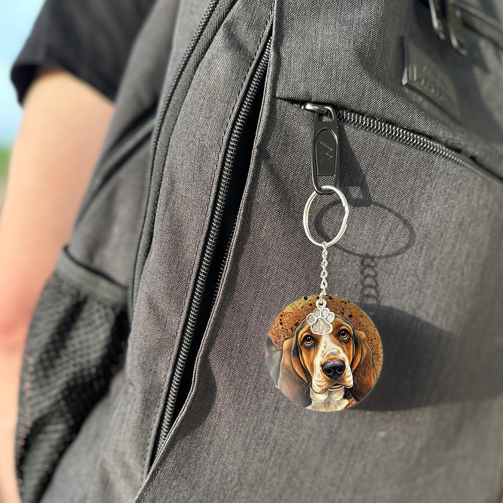 Keychain with a dog's face attached to a gray bag