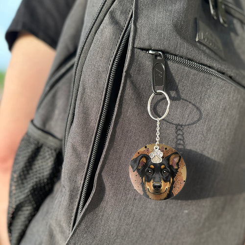 Keychain with a dog's face attached to a gray bag