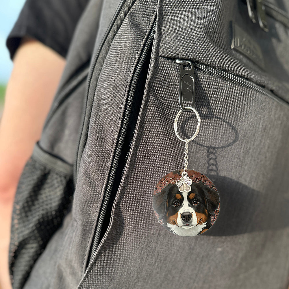Keychain with a dog's face attached to a gray bag