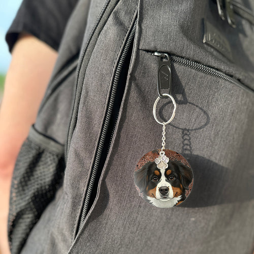 Keychain with a dog's face attached to a gray bag
