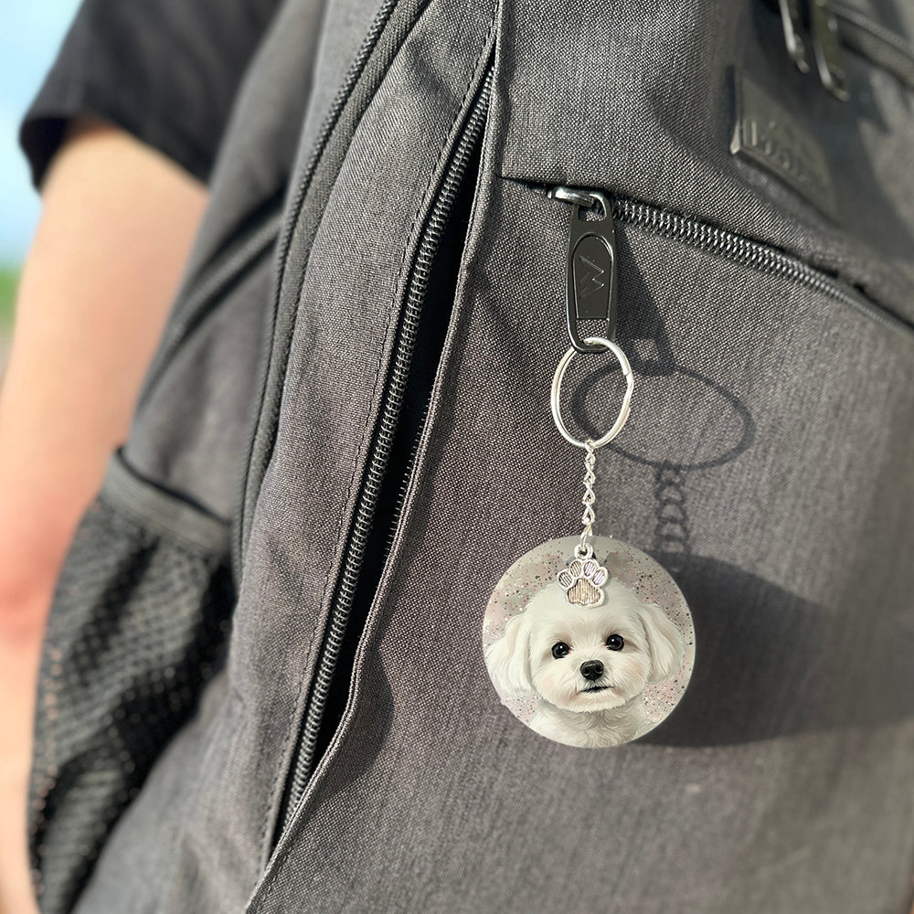 Keychain with a dog's face attached to a gray bag