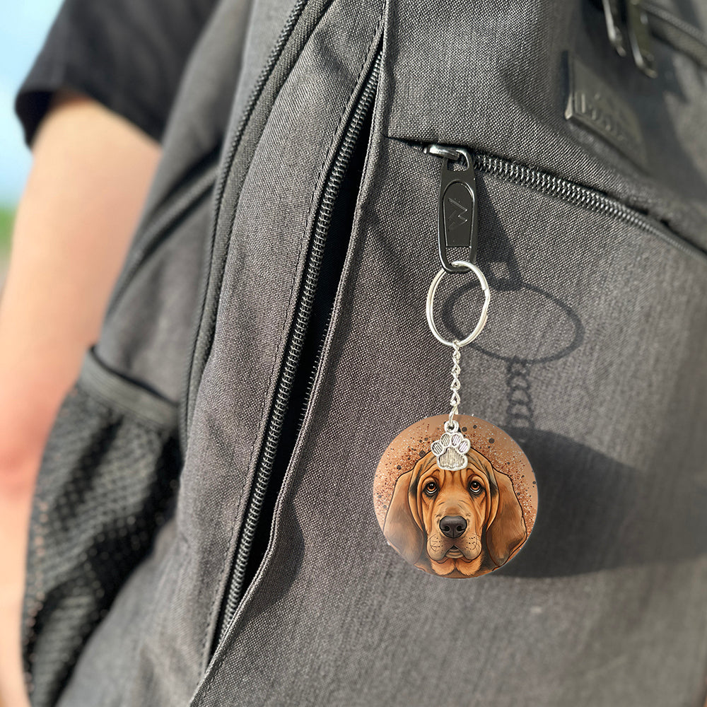 Keychain with a dog's face attached to a gray bag