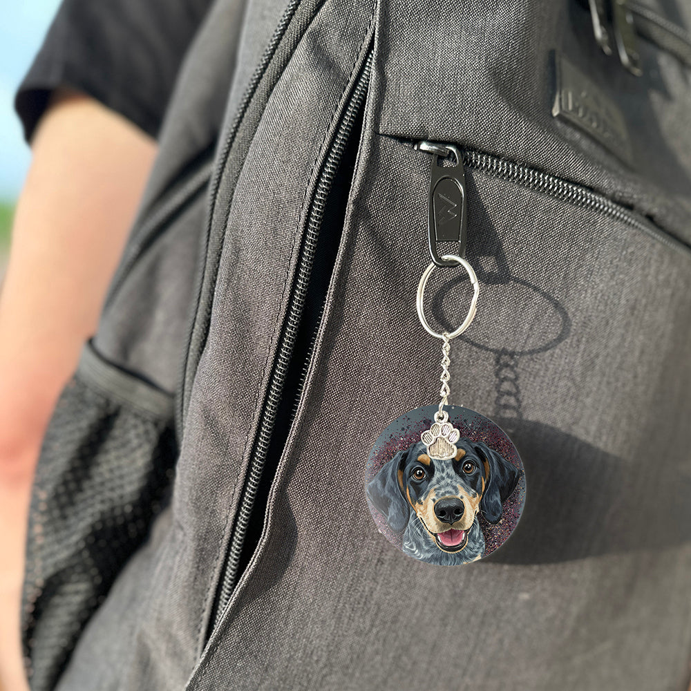 Keychain with a dog's face attached to a gray bag