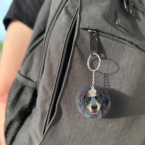 Keychain with a dog's face attached to a gray bag