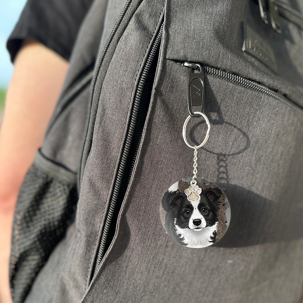 Keychain with a dog's face attached to a gray bag