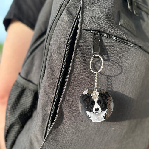 Keychain with a dog's face attached to a gray bag