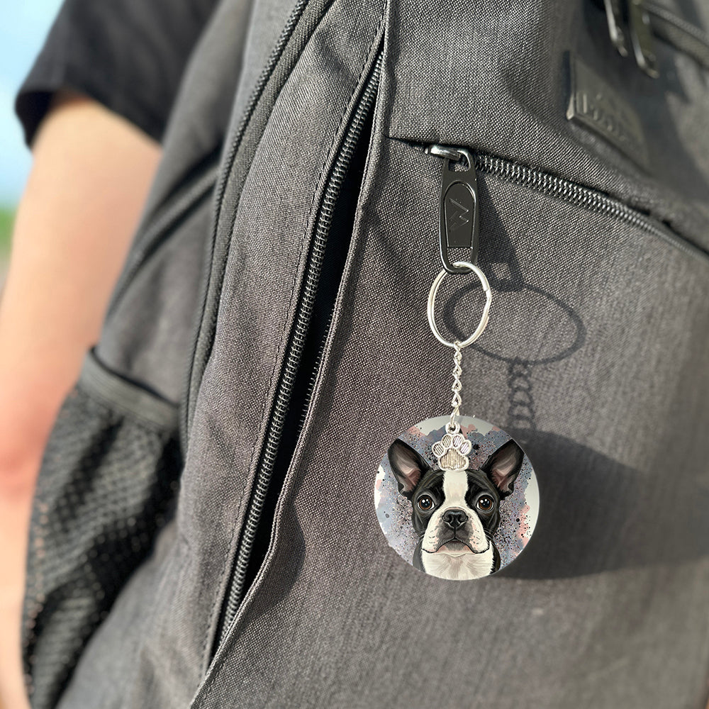Keychain with a dog's face attached to a gray bag