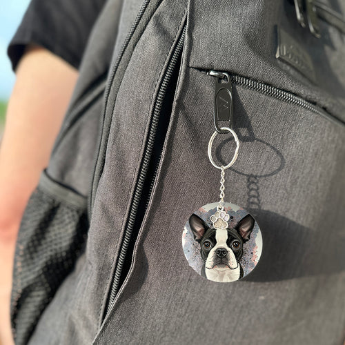 Keychain with a dog's face attached to a gray bag