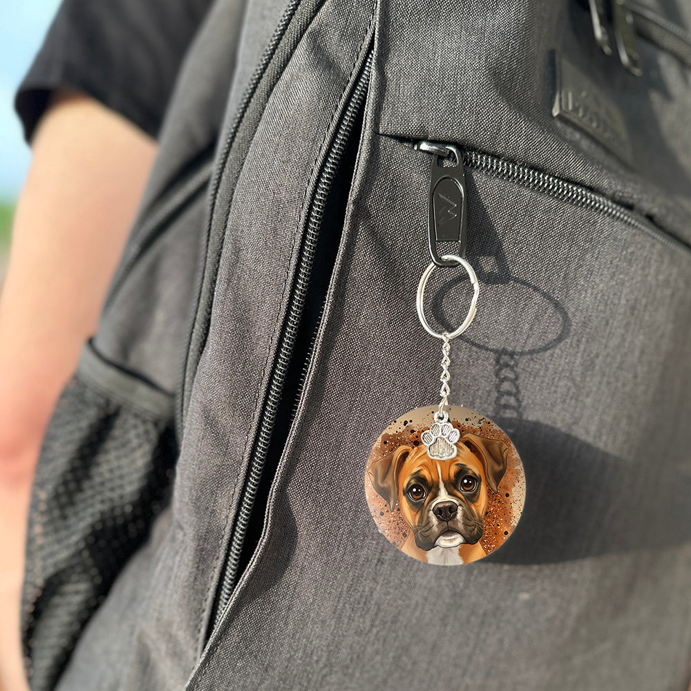 Keychain with a dog's face attached to a gray bag