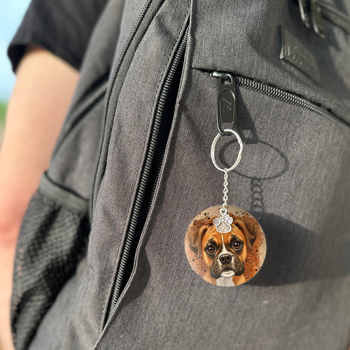 Keychain with a dog's face attached to a gray bag