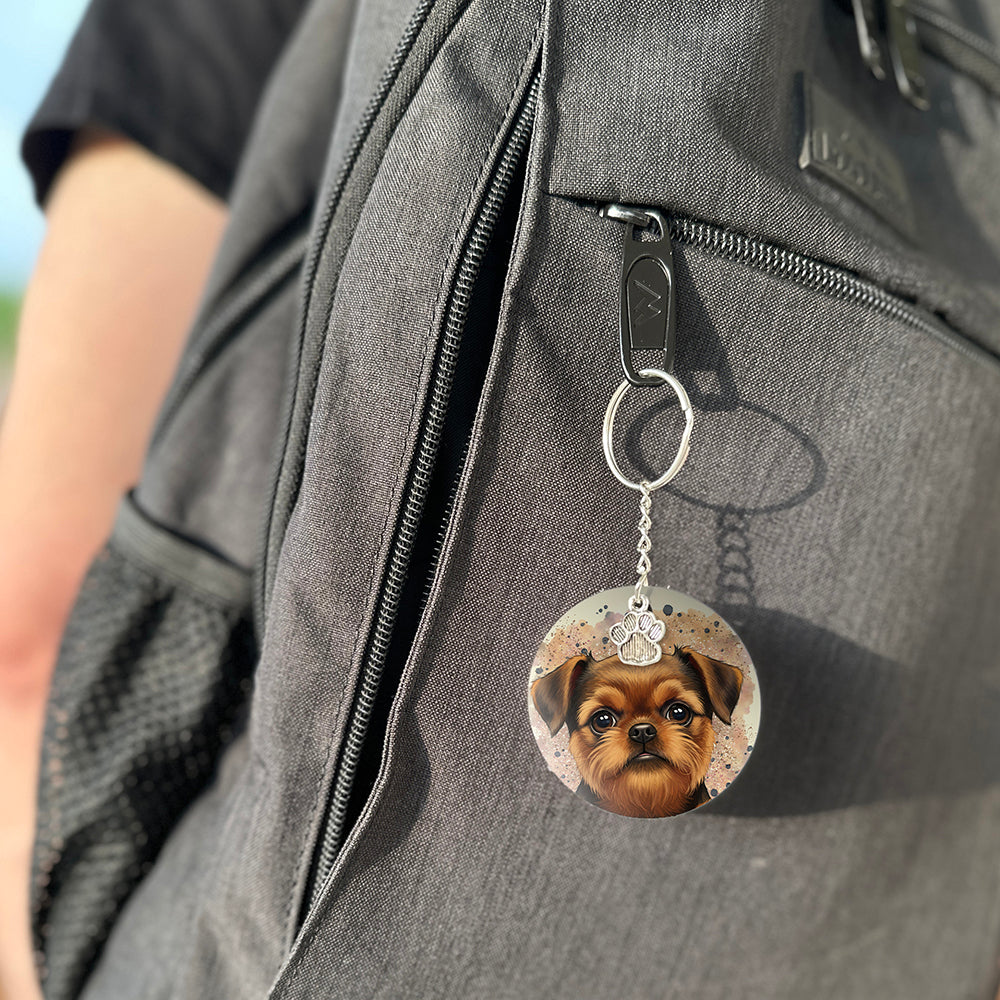 Keychain with a dog's face attached to a gray bag