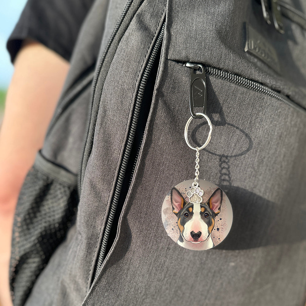 Keychain with a dog's face attached to a gray bag