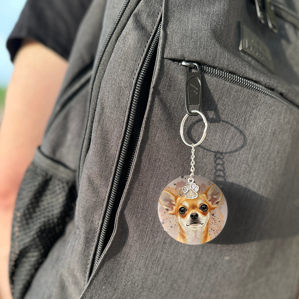 Keychain with a dog's face attached to a gray bag