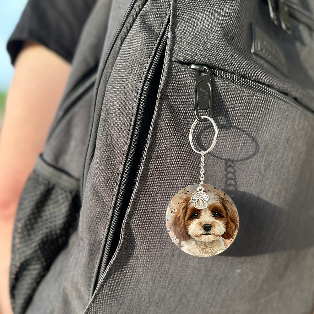 Keychain with a dog's face attached to a gray bag