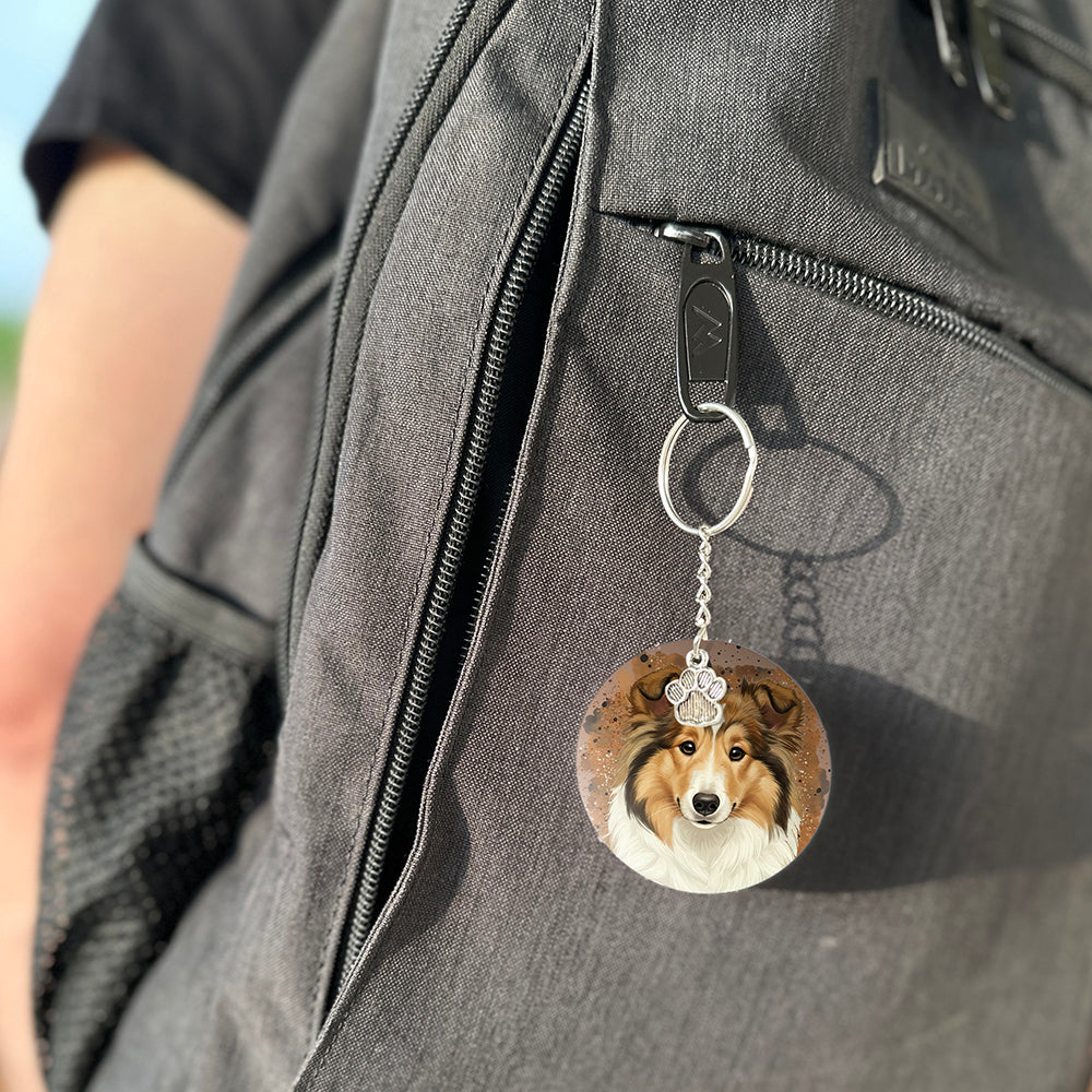 Keychain with a dog's face attached to a gray bag