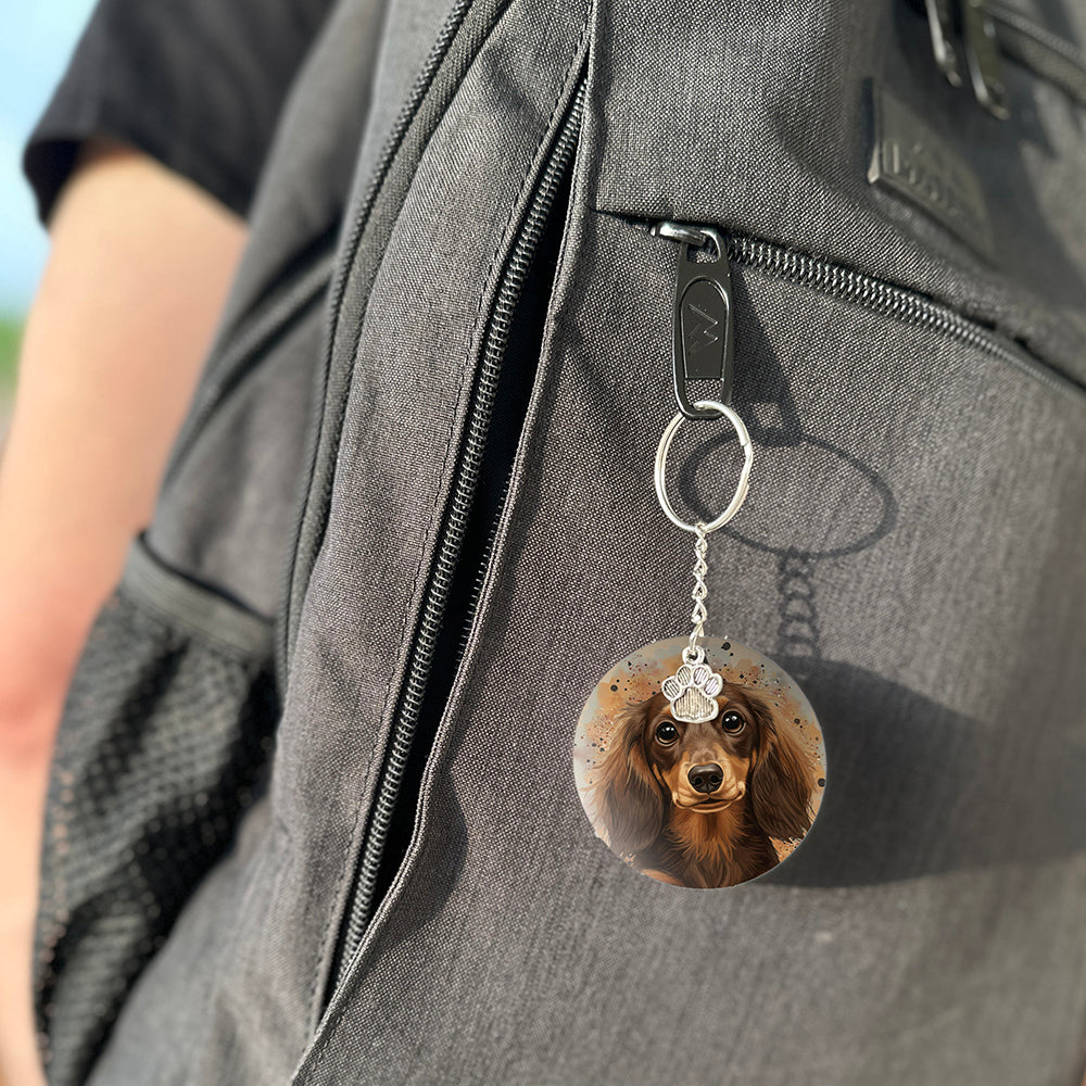 Keychain with a dog's face attached to a gray bag