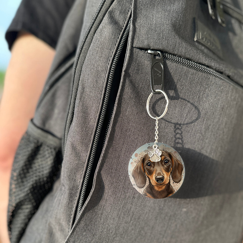Keychain with a dog's face attached to a gray bag